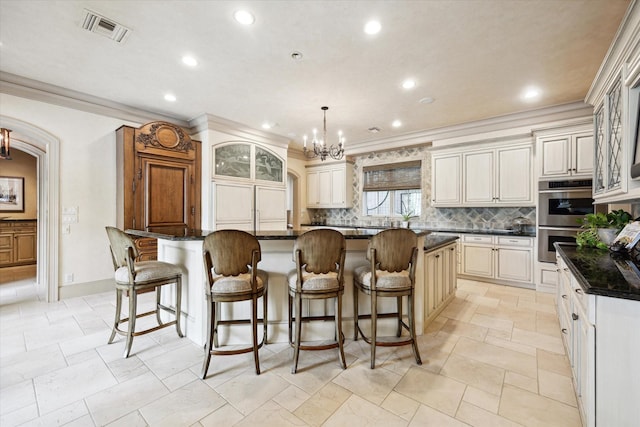 3019 Sunset Blvd, Houston, TX 77005 - kitchen featuring a chandelier, backsplash, recessed lighting, stainless steel double oven, and crown molding