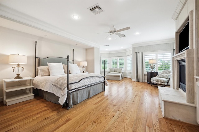3019 Sunset Blvd, Houston, TX 77005 - bedroom featuring a fireplace with raised hearth, ornamental molding, light wood finished floors, recessed lighting, and ceiling fan