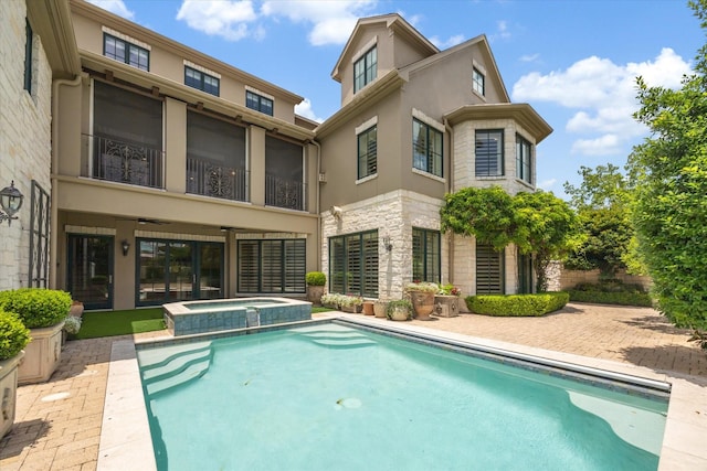 3019 Sunset Blvd, Houston, TX 77005 - back of property with stone siding, stucco siding, a ceiling fan, a pool with connected hot tub, and a patio area