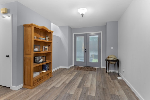 4220 Kenbrook Dr, Nacogdoches, TX 75965 - entrance foyer with french doors, light wood-type flooring, and baseboards