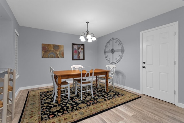 4220 Kenbrook Dr, Nacogdoches, TX 75965 - dining area featuring wood finished floors, a chandelier, and baseboards