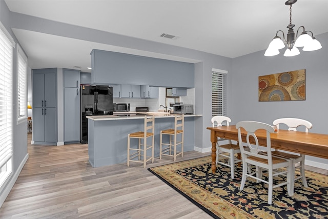 4220 Kenbrook Dr, Nacogdoches, TX 75965 - dining room with a chandelier, light wood finished floors, baseboards, and healthy amount of natural light
