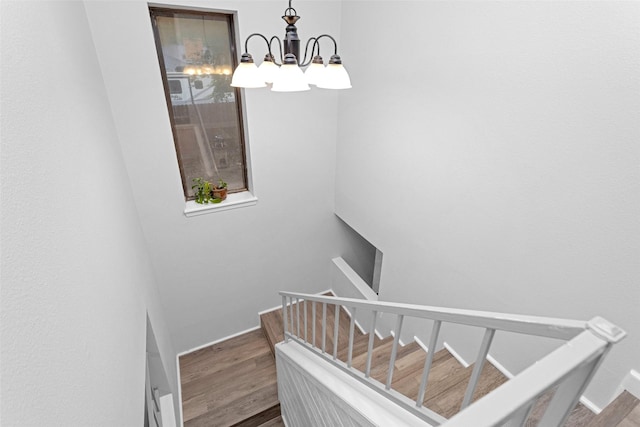 4220 Kenbrook Dr, Nacogdoches, TX 75965 - stairs with a chandelier, wood finished floors, and baseboards