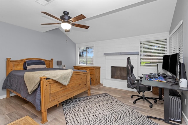 4220 Kenbrook Dr, Nacogdoches, TX 75965 - bedroom with lofted ceiling, wood finished floors, an office area, a fireplace, and a ceiling fan