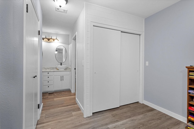 4220 Kenbrook Dr, Nacogdoches, TX 75965 - bathroom with wood finished floors, vanity, and baseboards