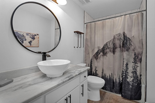 4220 Kenbrook Dr, Nacogdoches, TX 75965 - full bathroom with vanity, toilet, wood finished floors, and a shower with shower curtain