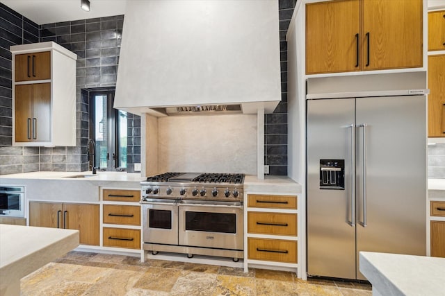 721 Harborside Way, League City, TX 77565 - kitchen featuring high end appliances, a sink, custom exhaust hood, light countertops, and decorative backsplash