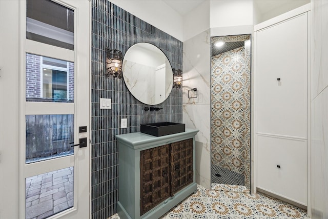 721 Harborside Way, League City, TX 77565 - full bathroom featuring tile walls, tiled shower, a sink, and tile patterned floors