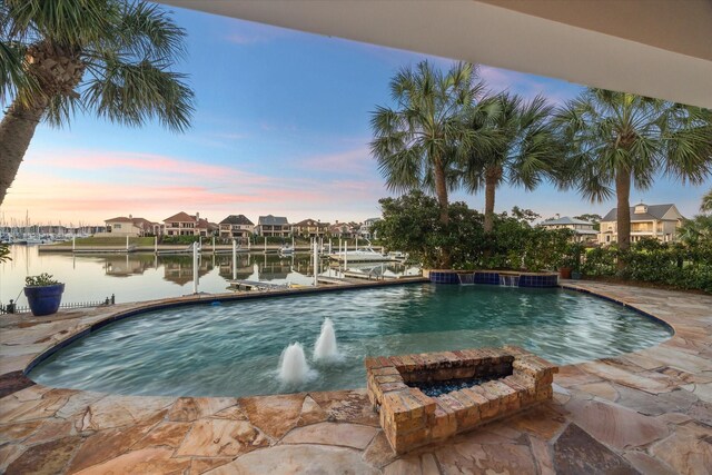 721 Harborside Way, League City, TX 77565 - view of swimming pool featuring a dock, a water view, boat lift, and a pool with connected hot tub