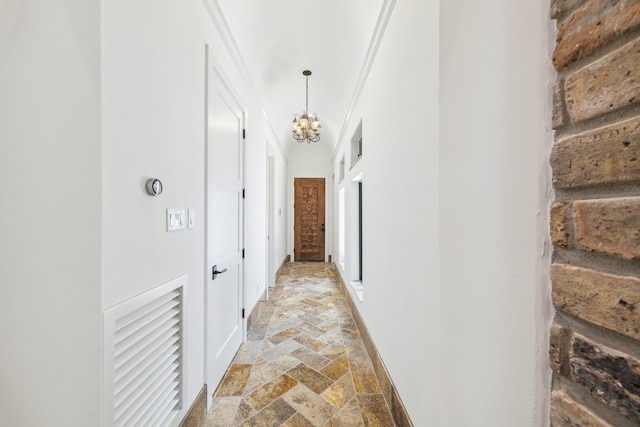 721 Harborside Way, League City, TX 77565 - hallway with stone tile flooring, a chandelier, baseboards, and crown molding