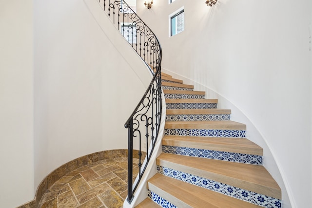 721 Harborside Way, League City, TX 77565 - staircase with a high ceiling and stone finish flooring
