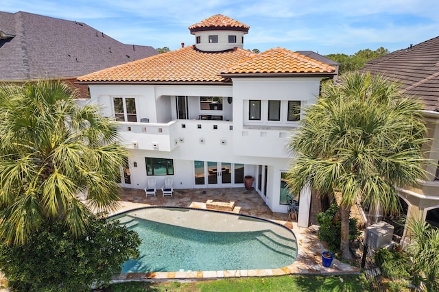 721 Harborside Way, League City, TX 77565 - rear view of property featuring stucco siding, a tile roof, an outdoor pool, and french doors