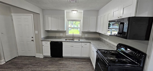 215 San Jacinto St, Highlands, TX 77562 - kitchen featuring black appliances, a sink, white cabinetry, dark wood-style floors, and a textured ceiling