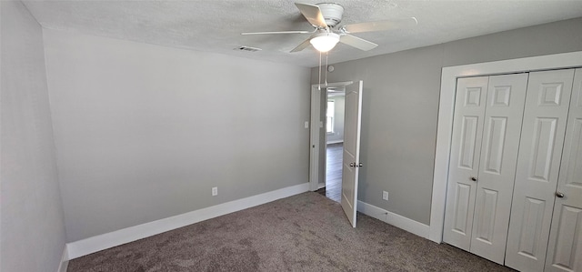 215 San Jacinto St, Highlands, TX 77562 - unfurnished bedroom with carpet, a closet, baseboards, a ceiling fan, and a textured ceiling