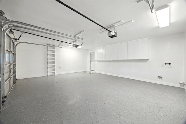 1309 Centennial Dr, Houston, TX 77055 - garage featuring a garage door opener and baseboards