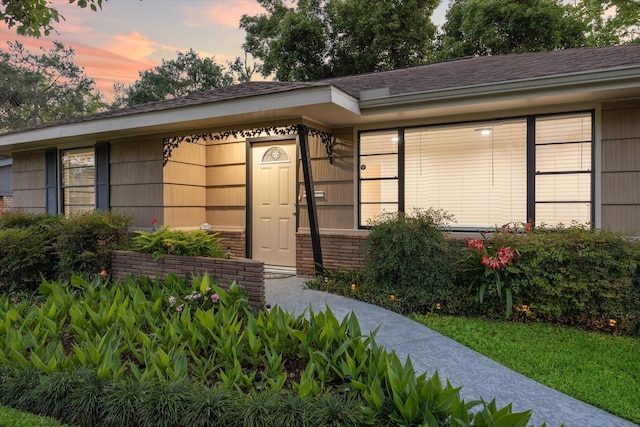 1309 Centennial Dr, Houston, TX 77055 - doorway to property featuring a shingled roof and brick siding