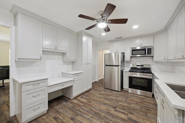 1309 Centennial Dr, Houston, TX 77055 - kitchen featuring stainless steel appliances, a ceiling fan, recessed lighting, dark wood-style flooring, and white cabinetry