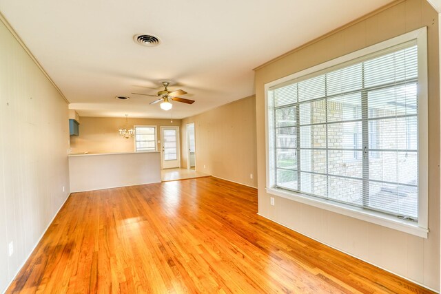 10134 Brinwood Dr, Houston, TX 77043 - unfurnished room featuring wood finished floors, ceiling fan, and a chandelier