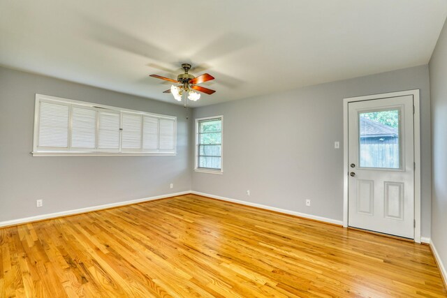10134 Brinwood Dr, Houston, TX 77043 - unfurnished room with plenty of natural light, ceiling fan, baseboards, and light wood finished floors