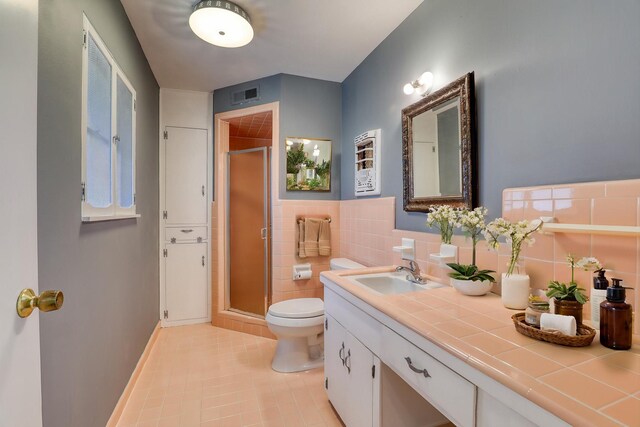 10134 Brinwood Dr, Houston, TX 77043 - full bath with tile patterned floors, a stall shower, toilet, and vanity