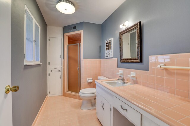10134 Brinwood Dr, Houston, TX 77043 - bathroom with toilet, a shower stall, tile patterned flooring, and vanity