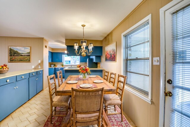 10134 Brinwood Dr, Houston, TX 77043 - dining area with a chandelier and wood walls
