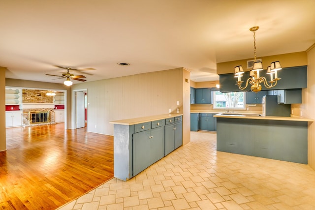10134 Brinwood Dr, Houston, TX 77043 - kitchen featuring a chandelier, open floor plan, ceiling fan, blue cabinets, and a peninsula