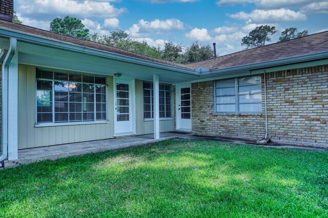 10134 Brinwood Dr, Houston, TX 77043 - rear view of house with a yard, brick siding, and a chimney