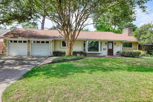 10134 Brinwood Dr, Houston, TX 77043 - single story home featuring an attached garage, a chimney, concrete driveway, and a shingled roof