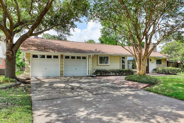 10134 Brinwood Dr, Houston, TX 77043 - single story home with a garage, driveway, and a chimney