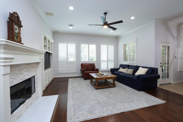 6 Lovenote Ct, The Woodlands, TX 77382 - living area with a ceiling fan, dark wood-type flooring, a glass covered fireplace, crown molding, and recessed lighting