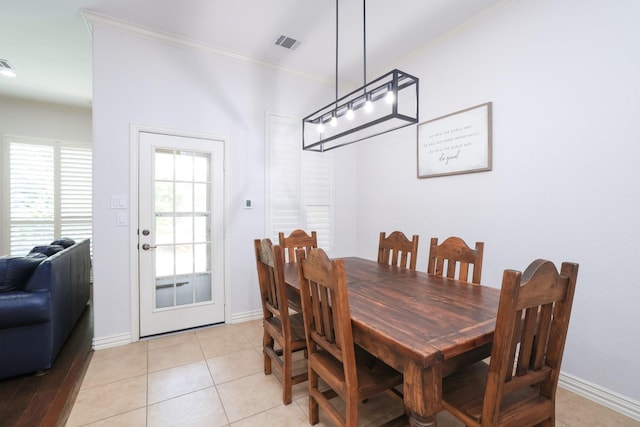 6 Lovenote Ct, The Woodlands, TX 77382 - dining space with crown molding, baseboards, and light tile patterned floors