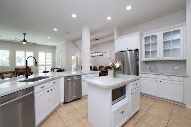 6 Lovenote Ct, The Woodlands, TX 77382 - kitchen featuring stainless steel appliances, a sink, light tile patterned flooring, backsplash, and recessed lighting