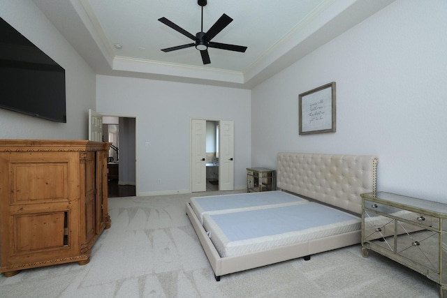 6 Lovenote Ct, The Woodlands, TX 77382 - bedroom featuring light colored carpet, ornamental molding, a tray ceiling, baseboards, and a ceiling fan