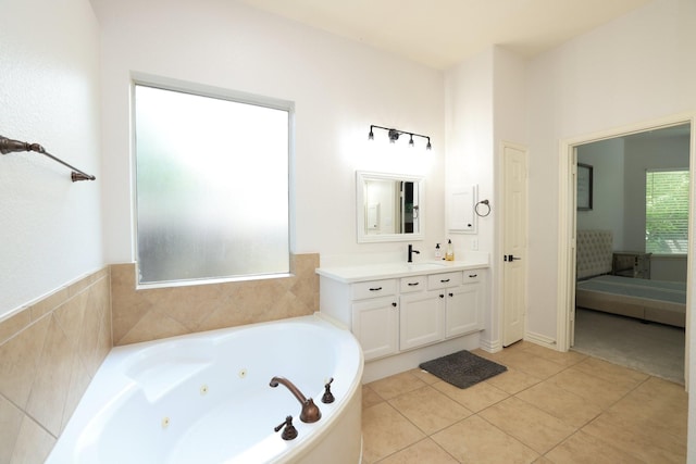 6 Lovenote Ct, The Woodlands, TX 77382 - bathroom featuring a jetted tub, vanity, and tile patterned flooring