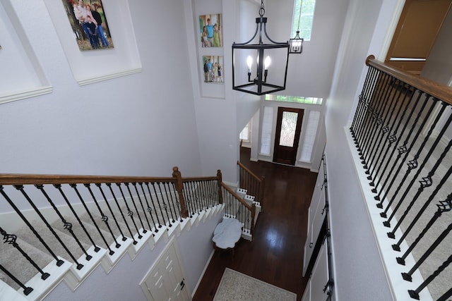 6 Lovenote Ct, The Woodlands, TX 77382 - foyer entrance with wood finished floors, a chandelier, stairs, and a high ceiling