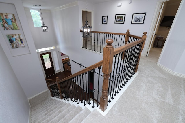 6 Lovenote Ct, The Woodlands, TX 77382 - stairway featuring a chandelier, carpet, and baseboards