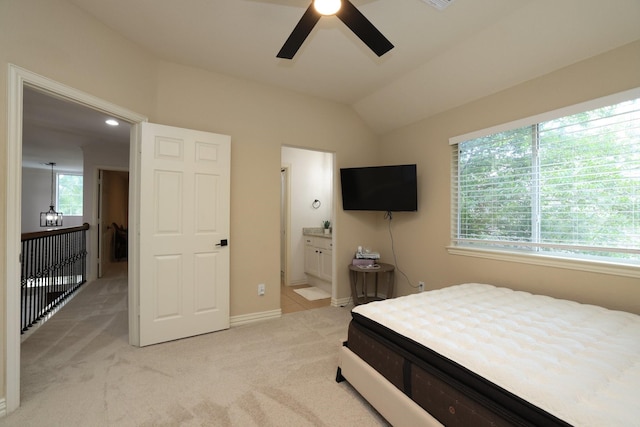 6 Lovenote Ct, The Woodlands, TX 77382 - bedroom featuring light carpet, vaulted ceiling, ensuite bath, baseboards, and a ceiling fan