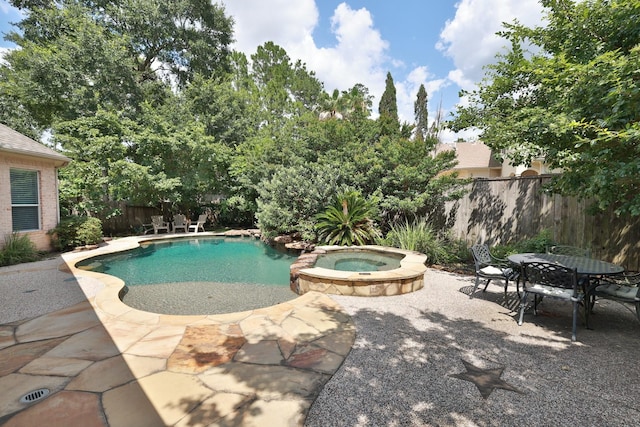 6 Lovenote Ct, The Woodlands, TX 77382 - view of swimming pool with a patio, a fenced backyard, a pool with connected hot tub, and outdoor dining space
