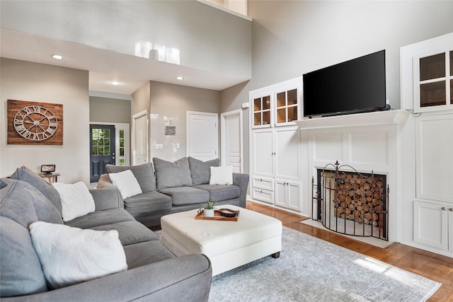 5318 E Plantation Oaks Dr, Arcola, TX 77583 - living area with wood finished floors, a towering ceiling, and recessed lighting