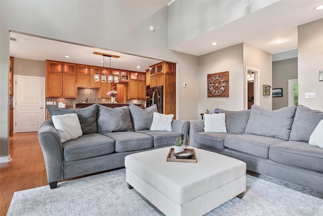 5318 E Plantation Oaks Dr, Arcola, TX 77583 - living room featuring light wood-style floors, recessed lighting, and a towering ceiling
