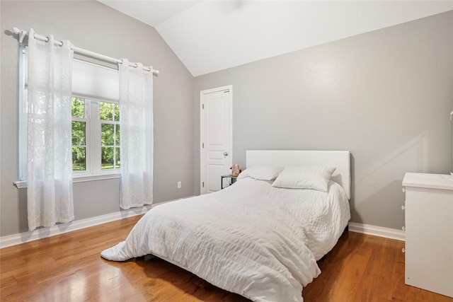5318 E Plantation Oaks Dr, Arcola, TX 77583 - bedroom featuring lofted ceiling, wood finished floors, and baseboards
