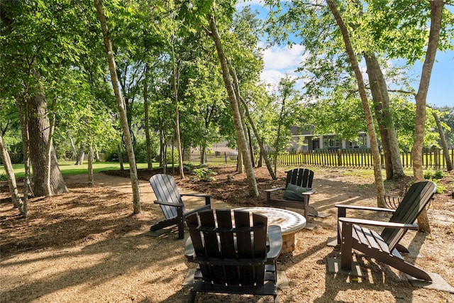 5318 E Plantation Oaks Dr, Arcola, TX 77583 - view of yard featuring an outdoor fire pit and view of wooded area