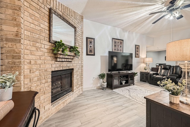 3106 Village Springs Ct, Houston, TX 77339 - living room featuring a ceiling fan, a fireplace, wood finished floors, a textured ceiling, and baseboards