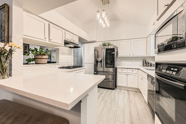 3106 Village Springs Ct, Houston, TX 77339 - kitchen featuring black appliances, light countertops, decorative backsplash, a peninsula, and under cabinet range hood