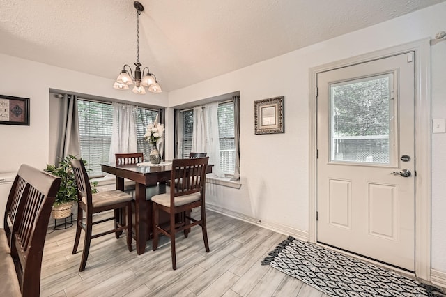 3106 Village Springs Ct, Houston, TX 77339 - dining space featuring a chandelier, light wood-type flooring, baseboards, and a textured ceiling