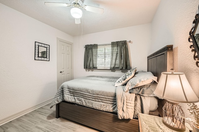 3106 Village Springs Ct, Houston, TX 77339 - bedroom with baseboards, wood finished floors, a textured wall, ceiling fan, and a textured ceiling