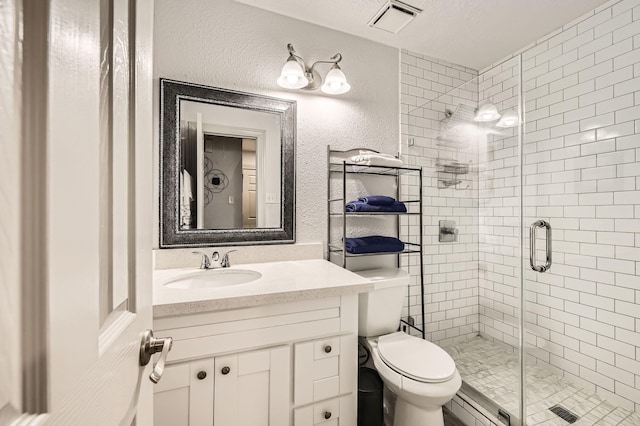 3106 Village Springs Ct, Houston, TX 77339 - full bathroom featuring a shower stall, vanity, toilet, and a textured wall