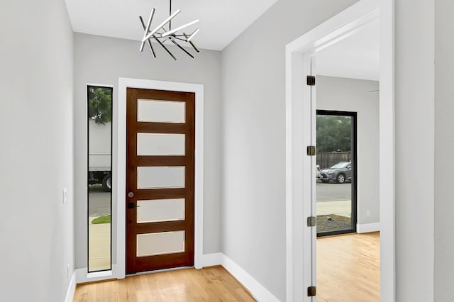 1505 Stuart St, Houston, TX 77004 - foyer entrance featuring a chandelier, light wood-style flooring, and baseboards