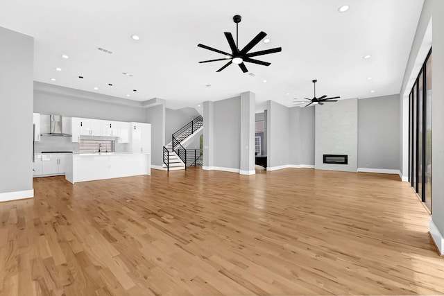 1505 Stuart St, Houston, TX 77004 - unfurnished living room featuring ceiling fan, light wood-style floors, recessed lighting, and baseboards